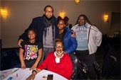 Photo of Norfolk Councilman John Paige posing with family during People First holiday party